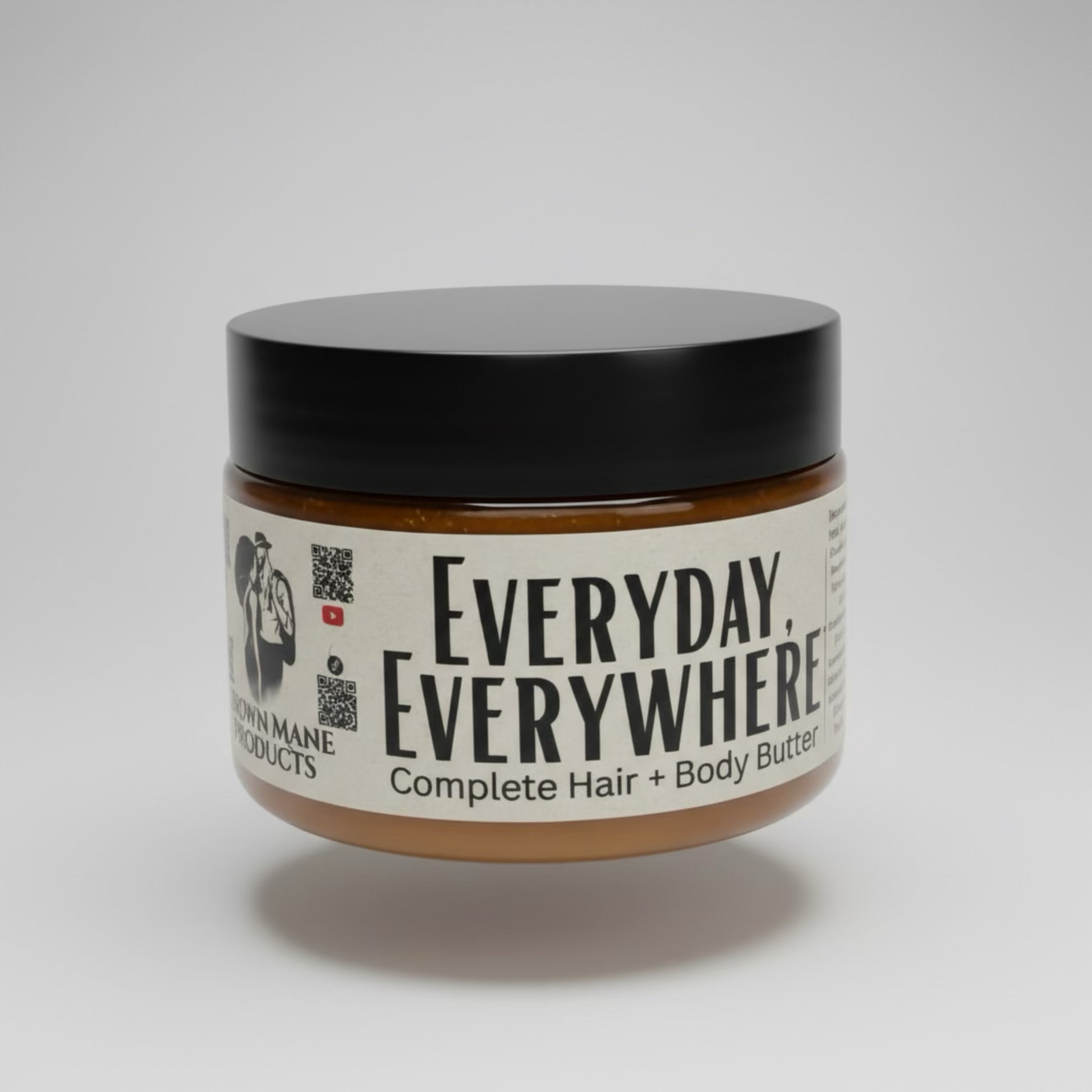 Jar of 'Everyday, Everywhere' complete hair and body butter on a gray background